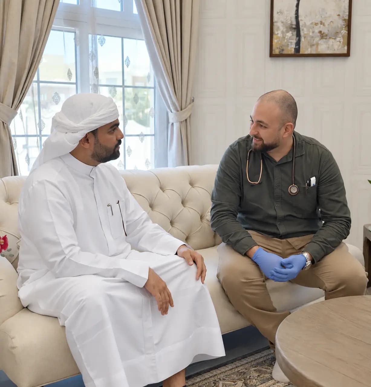 DHA-licensed doctor on a home visit consulting a patient in Dubai